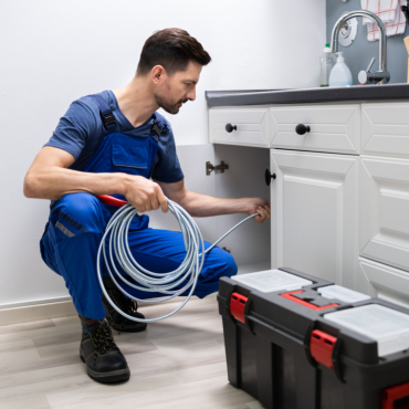 Plumber Cleaning Clogged Sink